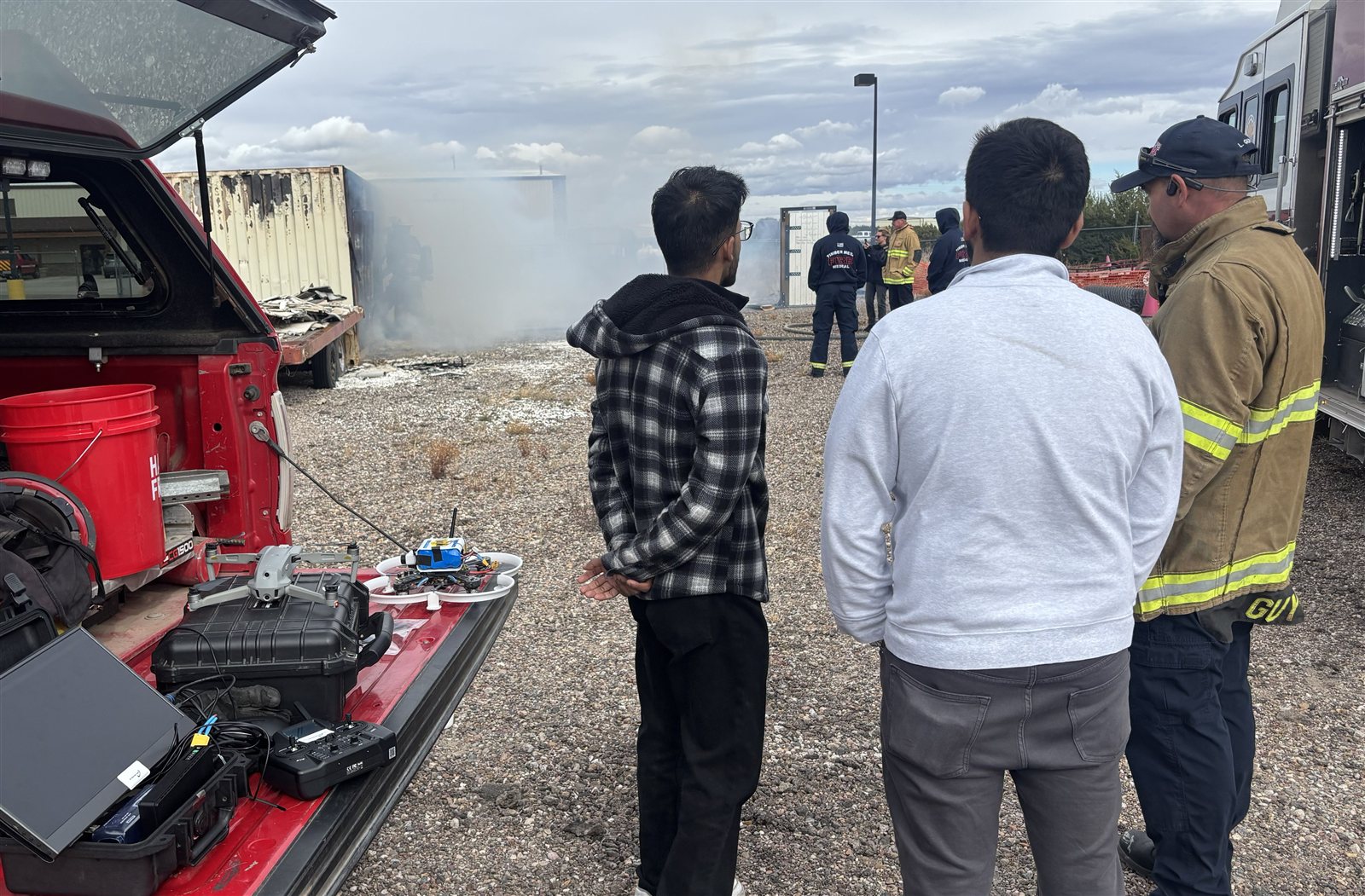 Skybourne team with firefighters at a live-fire field demonstration